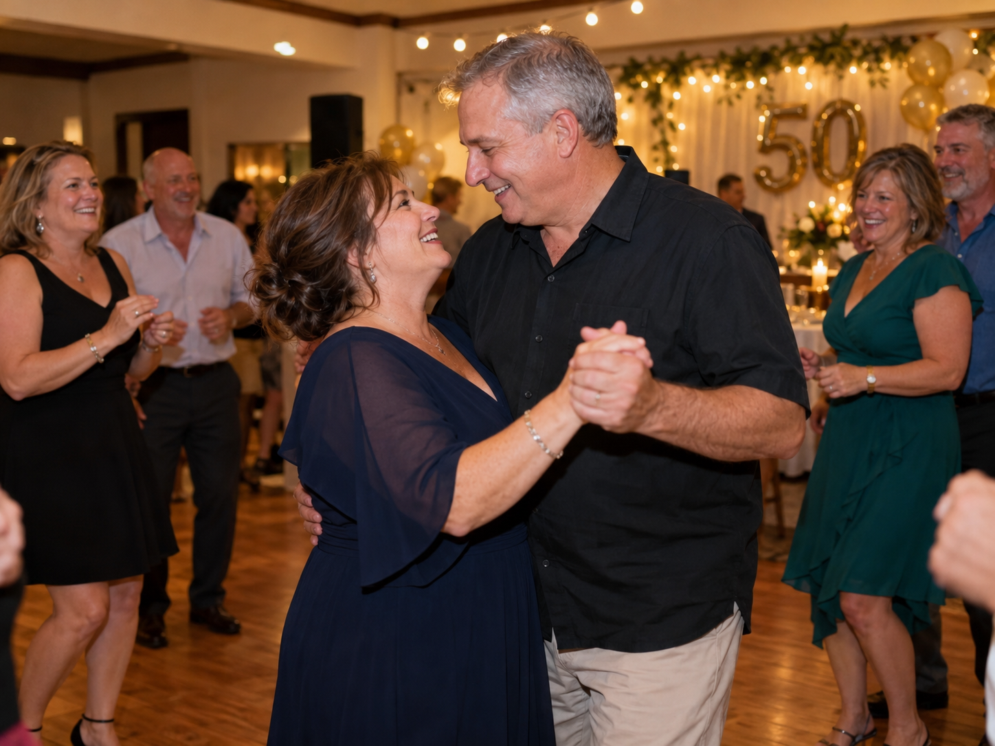 Guests enjoying music and dancing at a 50th anniversary party